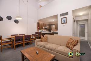 a living room with a couch and a dining room at Senedo Springs Duplex #97A in Basye