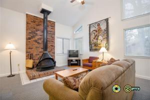 a living room with a couch and a fireplace at Senedo Springs Duplex #97B in Basye