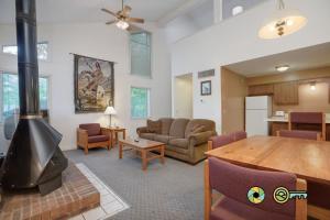 a living room with a fireplace and a dining room at Senedo Springs Duplex #97B in Basye