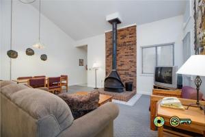 a living room with a couch and a fireplace at Senedo Springs Duplex #97B in Basye