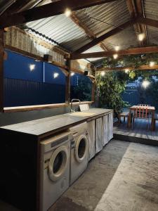 a outdoor kitchen with a sink and a washing machine at Forrest House Victor Harbor in Victor Harbor