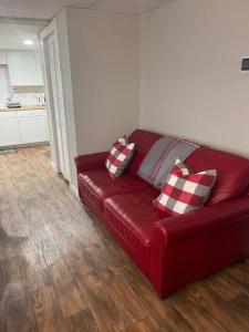 a red couch with two pillows on it in a living room at Lakeview 12B: Casa Uno Condo in Basye