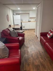 a living room with two red couches and a kitchen at Lakeview 12B: Casa Uno Condo in Basye +16 photos