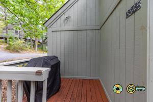 a house with a wooden deck with a garage at Lakeview 85B: Treehouse Mountain in Basye