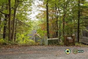 a park with a gas tank and trees and a house at Lakeview 85B: Treehouse Mountain in Basye