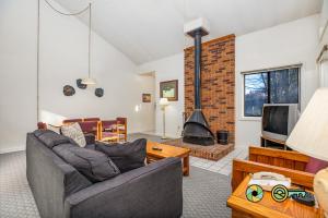a living room with a couch and a fireplace at Senedo Springs Duplex #98B in Basye