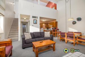 a living room with a couch and a table at Senedo Springs Duplex #98B in Basye