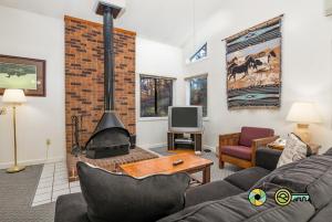 a living room with a couch and a fireplace at Senedo Springs Duplex #98B in Basye
