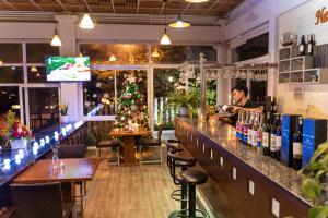 a man sitting at a bar in a restaurant at Navy Hotel Da Lat in Da Thien