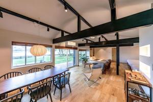 a living room with a large table and chairs at marinoe organic resort - Health and Stay - A Private Lakeside Villa at Lake Yamanaka, Blessed by the Spirit of Mount Fuji in Yamanakako