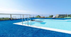 a swimming pool on top of a building at YU-FURI Izukogen in Ito