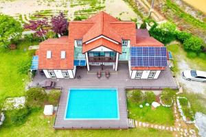 an aerial view of a house with a swimming pool at Anmyeondo Chingunae Pension in Taean