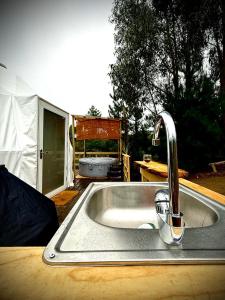 a kitchen sink with a faucet in front of a tent at APPA Glamping Domo 2 Jacuzzi privado in El Quisco