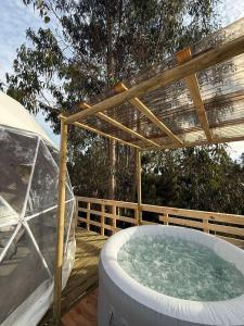 a hot tub on a wooden deck with a canopy at APPA Glamping Domo 2 Jacuzzi privado in El Quisco +14 photos