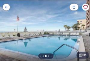 a large swimming pool with two icons for a photo of a building at Holiday villa 3 in Clearwater Beach