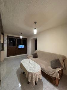 a bedroom with a bed and a table with a tv at Lucy Apartment Goris in Goris