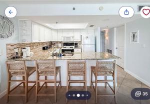 a kitchen with a large island with bar stools at Holiday villa 3 in Clearwater Beach