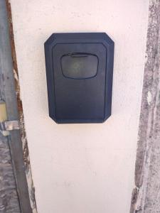 a black box on the side of a wall at Casa branca in Aracaju