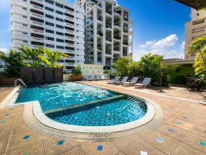 a swimming pool in the middle of a building at Woraburi Sukhumvit Hotel in Bangkok