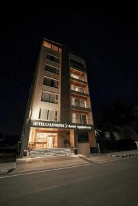 a hotel building with a sign on it at night at Hotel California in Bangalore