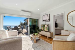 a living room with a view of the ocean at Sunkissed & Studio in Vincentia