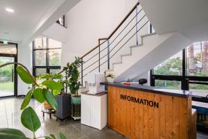 an information desk in a room with stairs at Dorami Pension in Seogwipo