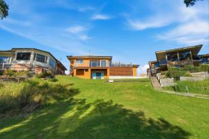 a group of houses on a grassy hill at Sunkissed & Studio in Vincentia