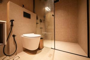 a bathroom with a shower and a toilet in it at Hotel California in Bangalore