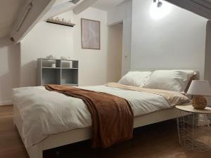 a bedroom with a bed with a blanket on it at Cocon 2 pièces - Design premium in Alfortville