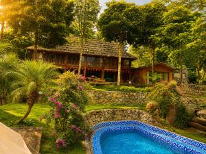 a house with a swimming pool in front of a house at Zenna Lake Retreat in Tien Xuan