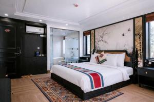 a bedroom with a large bed and a bathroom at Anara Sapa Hotel in Sapa