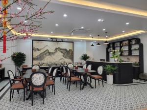 a restaurant with tables and chairs in a room at Anara Sapa Hotel in Sapa