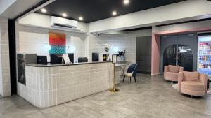 a lobby with a hair salon with chairs and a counter at The Metropolitan Spring Hill in Brisbane