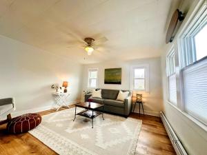a living room with a couch and a table at Shorebreak Cottage in North Kingstown