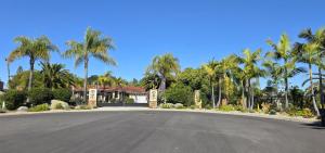 a street in front of a house with palm trees at Morning Glory Retreat-Private Lux 1-Bedroom Suite in a Tropical Resort Setting in Vista