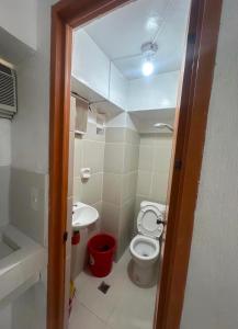a small bathroom with a toilet and a sink at RF Hotel Transient House in Bangued