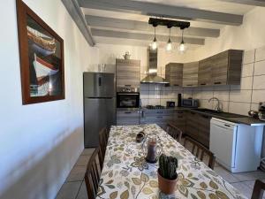 a kitchen with a table and a refrigerator at Le gîte sabotier in Nerbis
