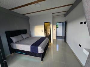 a bedroom with a bed and a hallway at Villa Yasmin in Prado