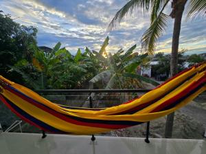 a colorful hammock sitting on top of a balcony at Villa Yasmin in Prado