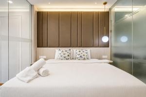 a bedroom with two beds with white sheets and pillows at Societe Hartamas in Kuala Lumpur +118 photos