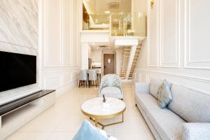 a living room with a couch and a table at Societe Hartamas in Kuala Lumpur