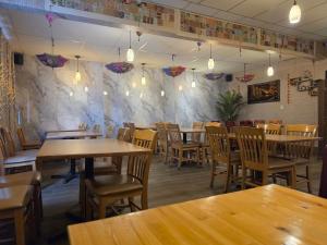 a dining room with wooden tables and chairs at Dinosaur Hotel in Drumheller