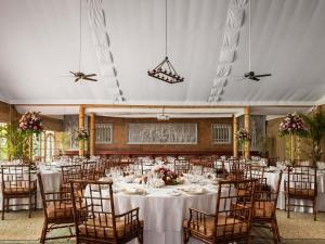 a banquet hall with white tables and chairs at Raffles Grand Hotel d'Angkor in Siem Reap +180 photos