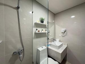 a bathroom with a shower and a toilet and a sink at Ocean Garden Villas 7th Floor - Road Side in Boracay +14 photos