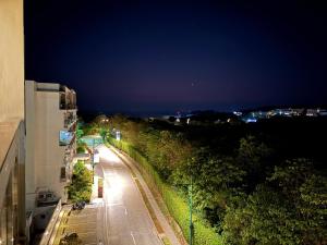 an empty street at night with a building at Ocean Garden Villas 7th Floor - Road Side in Boracay