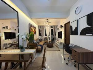 a living room with a couch and a table at Ocean Garden Villas 7th Floor - Road Side in Boracay