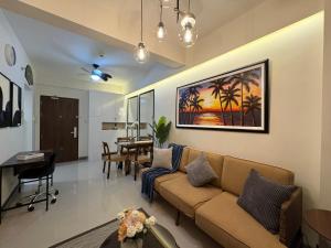 a living room with a couch and a table at Ocean Garden Villas 7th Floor - Road Side in Boracay