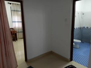 a bathroom with a toilet and a mirror at Muthu Villa in Negombo +40 photos
