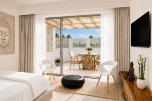 a bedroom with a bed and a table and chairs at BLACK AMBER BOUTIQUE HOTEL in Lampi