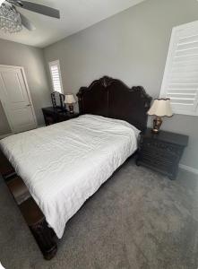 a bedroom with a large bed and two night stands at Bright and Cozy Bay Window Cottage 6 in Ontario